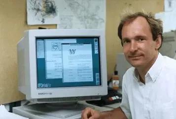  Tim Berners-Lee sitting next to an early computer displaying one of the first webpages on the World Wide Web.
